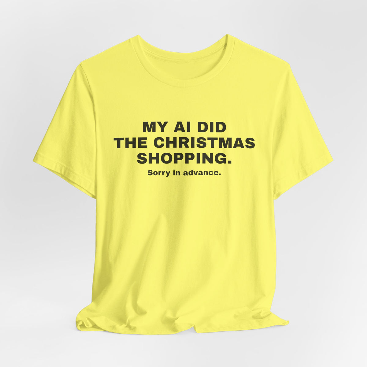 Yellow t-shirt printed with 'My AI Did the Christmas Shopping. Sorry in Advance.'