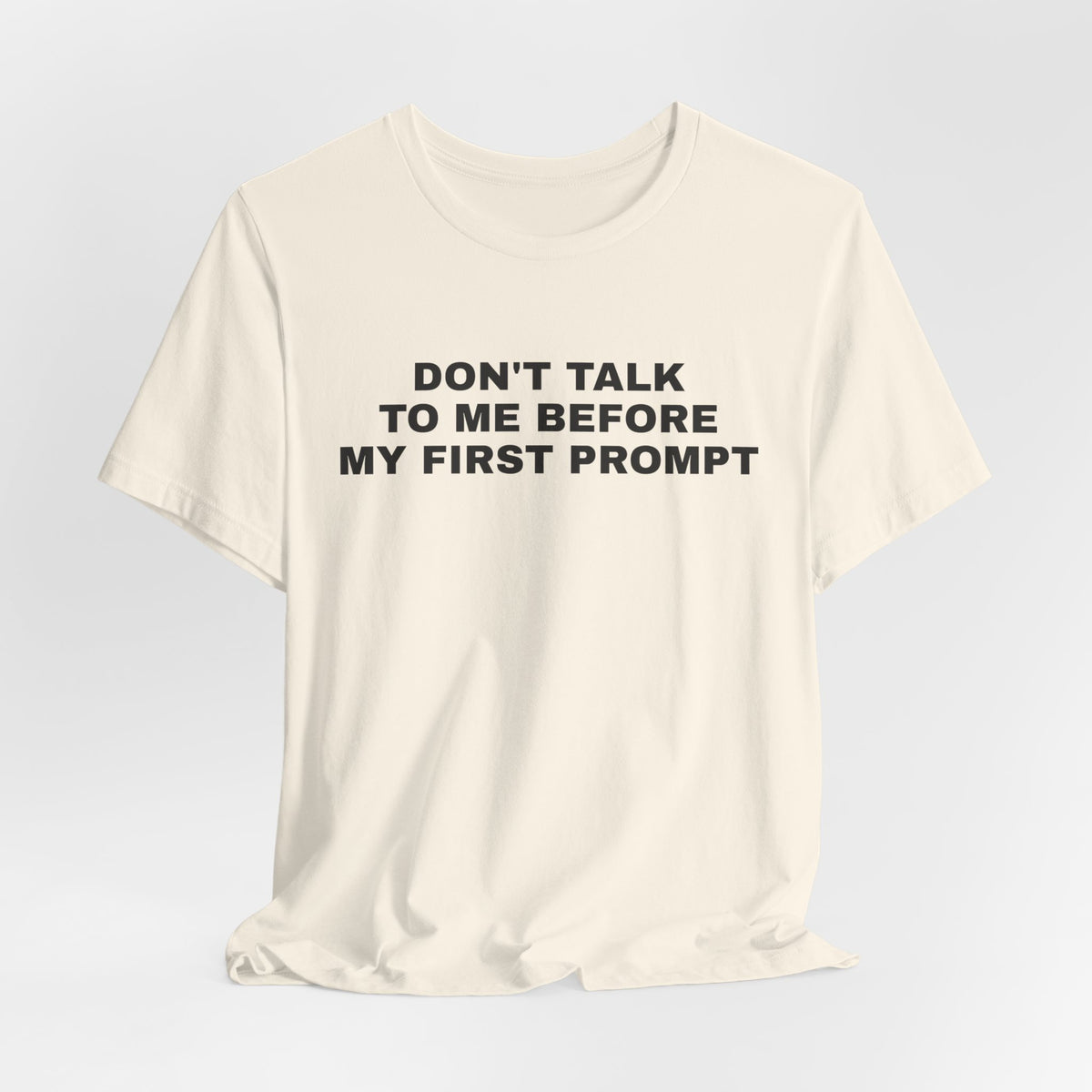 Natural t-shirt printed with 'Don't talk to me before my first prompt'