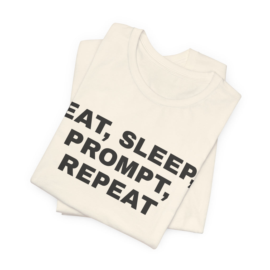 Natural t-shirt printed with 'Eat, sleep, prompt, repeat', folded