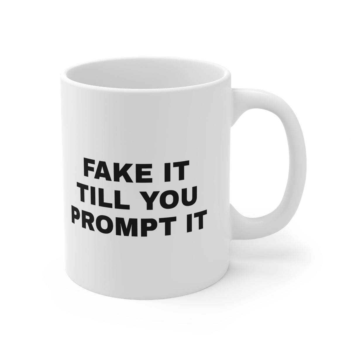 White mug printed with 'Fake it till you prompt it'