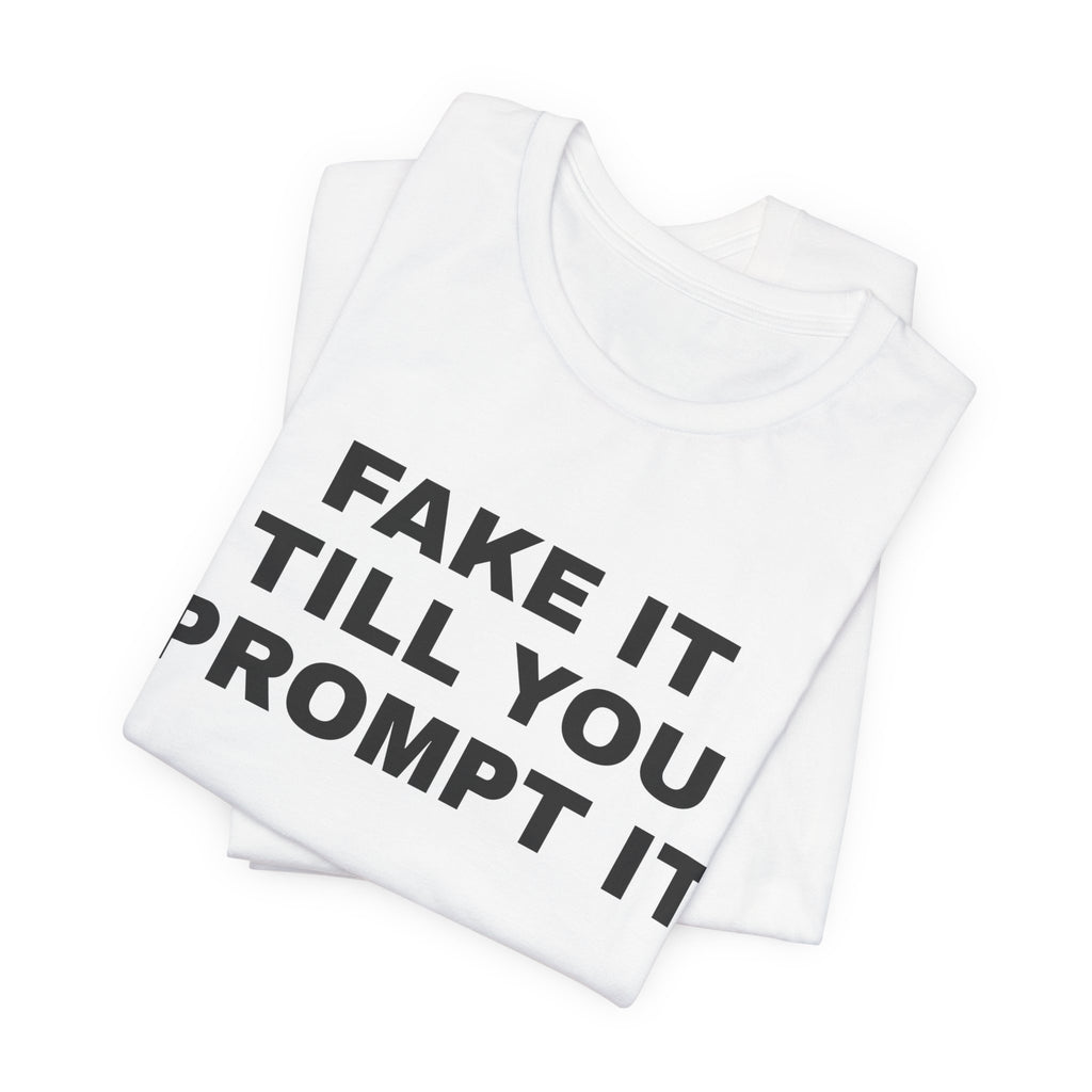 White t-shirt printed with 'Fake it till you prompt it', folded