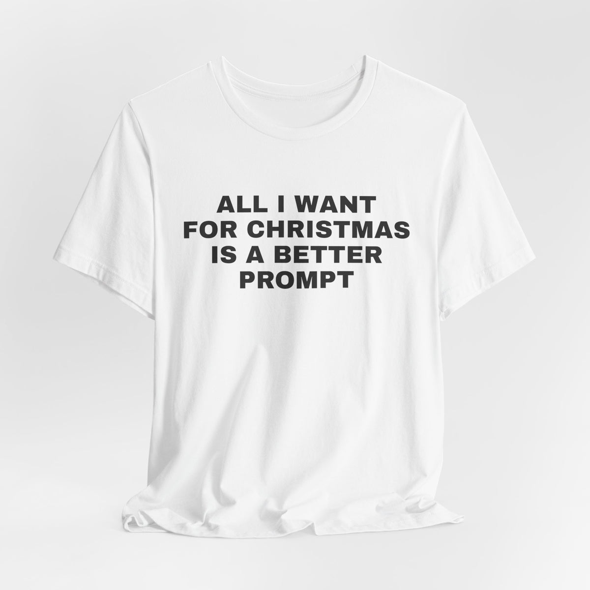 White t-shirt printed with 'All I want for Christmas is a better prompt'