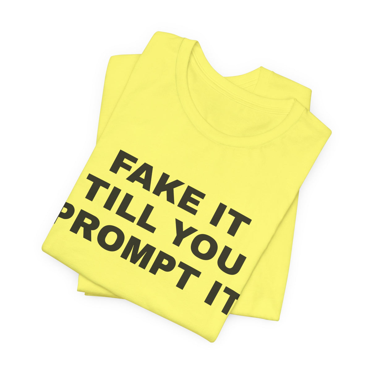 Yellow t-shirt printed with 'Fake it till you prompt it', folded
