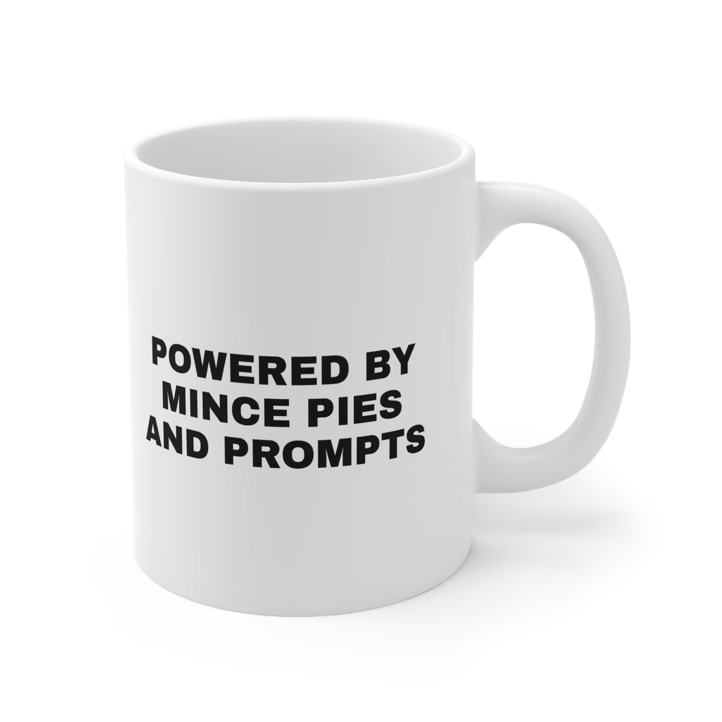 White mug printed with 'Powered by Mince Pies and Prompts'
