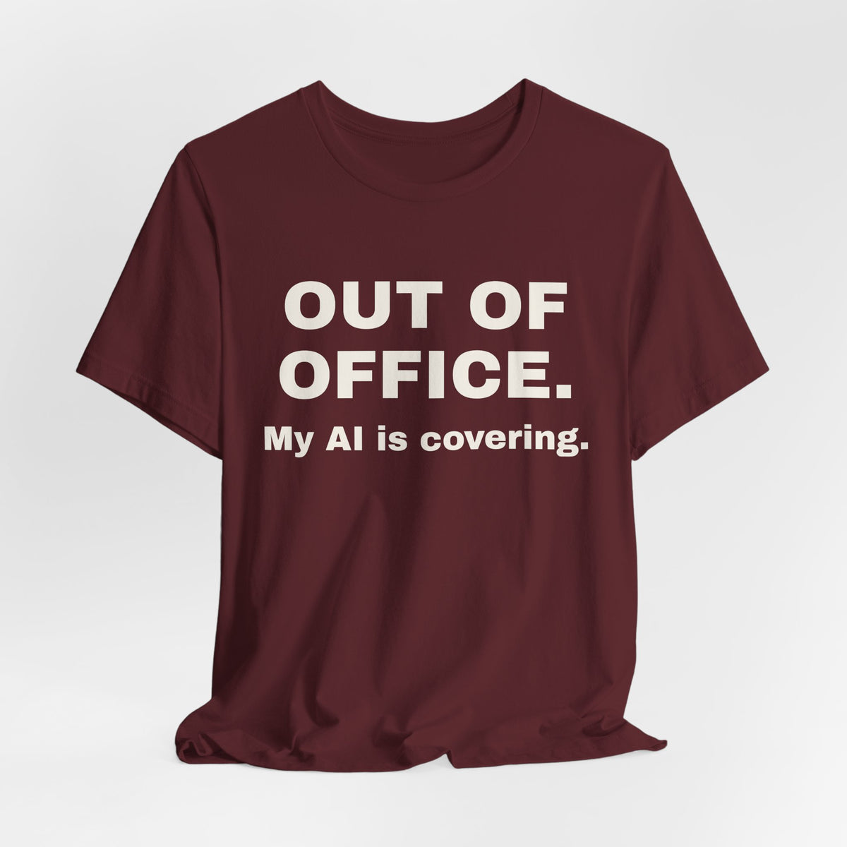 Maroon t-shirt printed with 'Out of office. My AI is covering.'