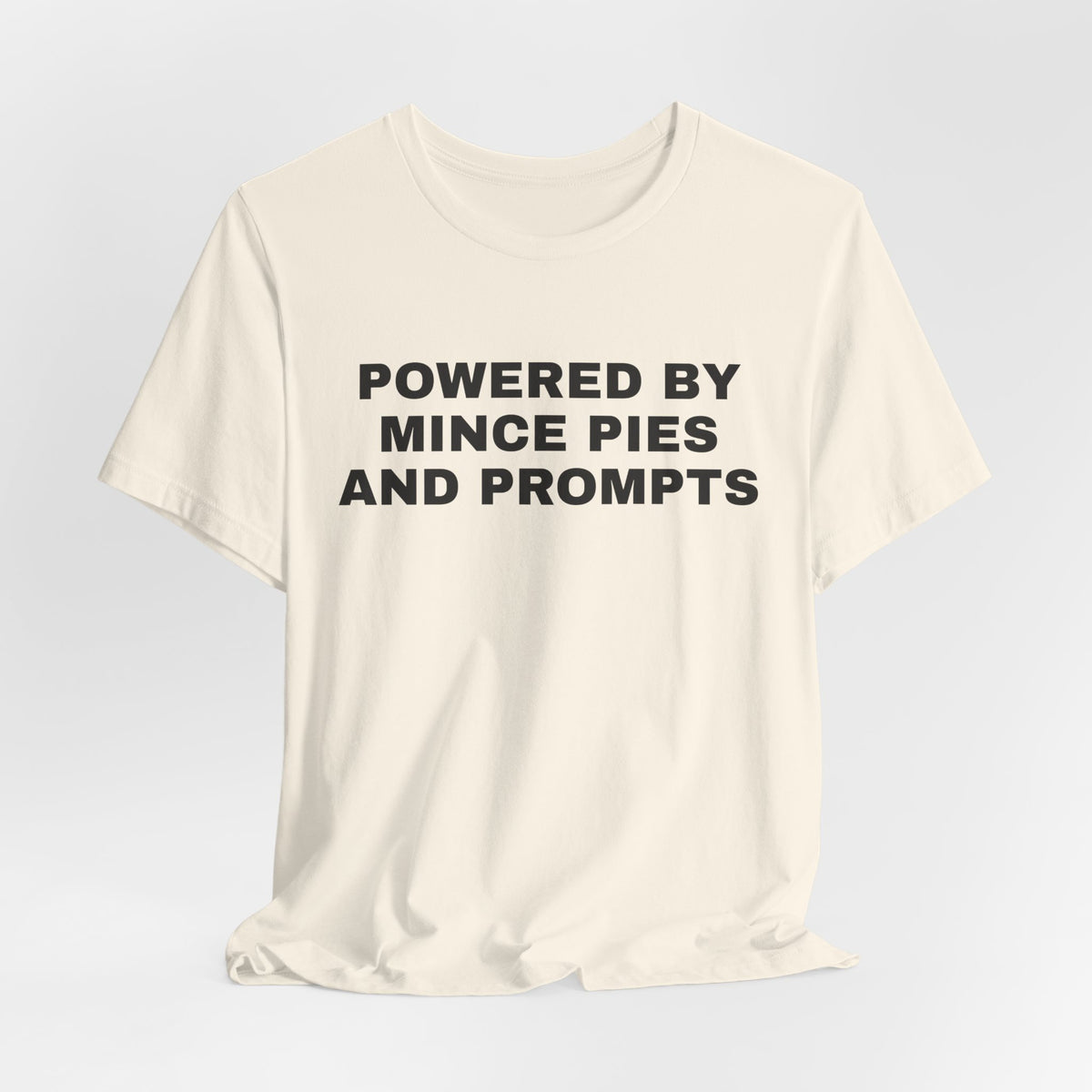 Natural t-shirt printed with 'Powered by Mince Pies and Prompts'
