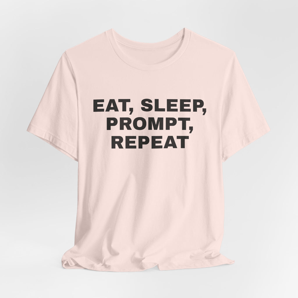 Soft pink t-shirt printed with 'Eat, sleep, prompt, repeat'