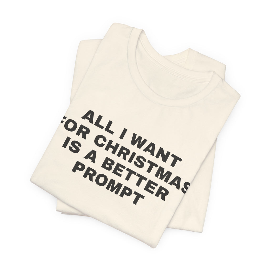 Natural t-shirt printed with 'All I want for Christmas is a better prompt', folded