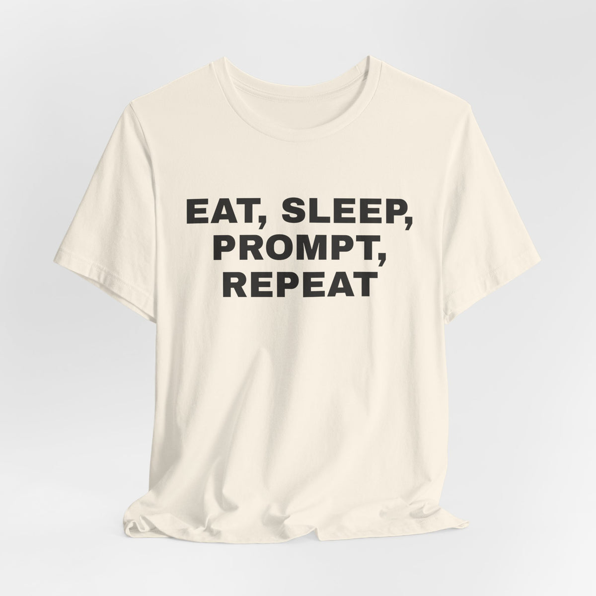 Natural t-shirt printed with 'Eat, sleep, prompt, repeat'