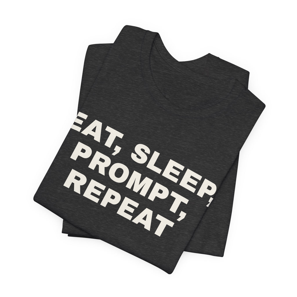 Dark grey heather t-shirt printed with 'Eat, sleep, prompt, repeat', folded