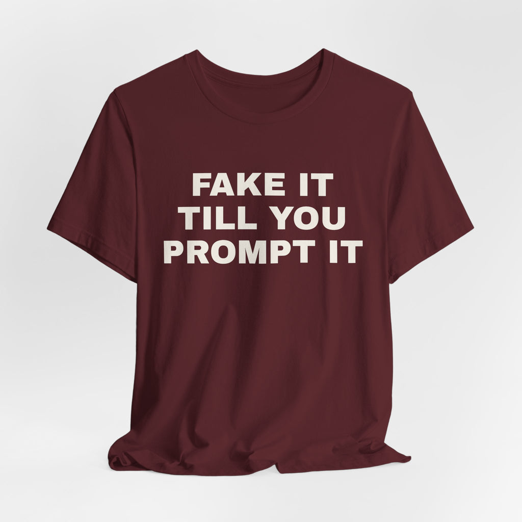 Maroon t-shirt printed with 'Fake it till you prompt it'