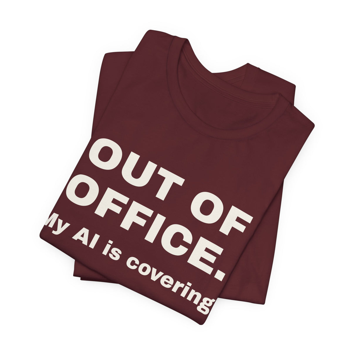 Maroon t-shirt printed with 'Out of office. My AI is covering.', folded