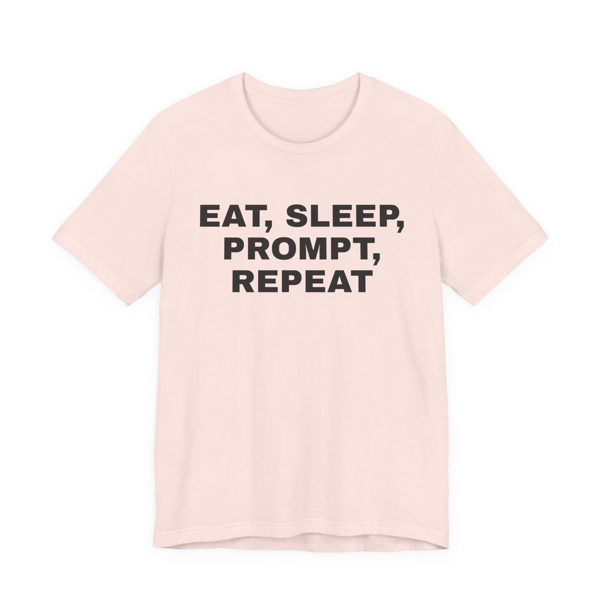 Soft pink t-shirt printed with 'Eat, sleep, prompt, repeat'