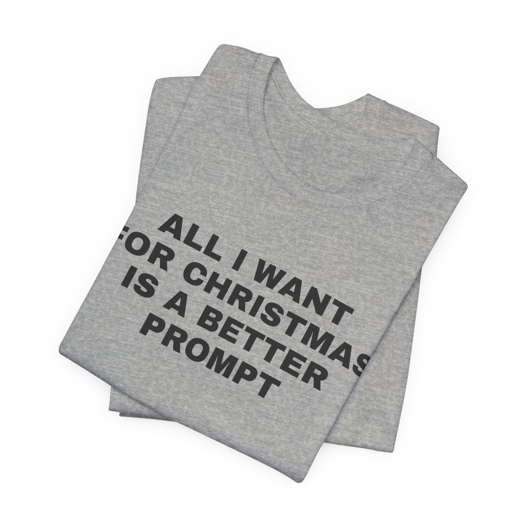 Athletic heather t-shirt printed with 'All I want for Christmas is a better prompt', folded