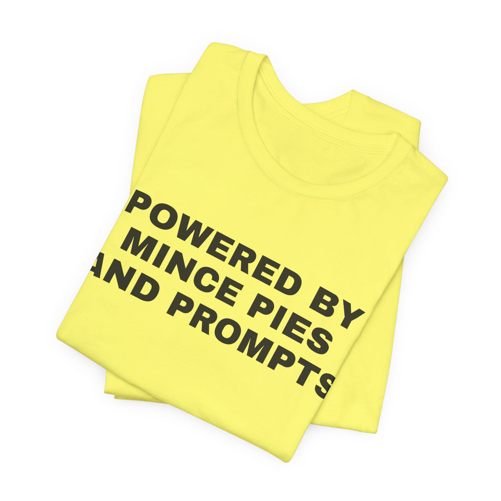 Yellow t-shirt printed with 'Powered by Mince Pies and Prompts', folded