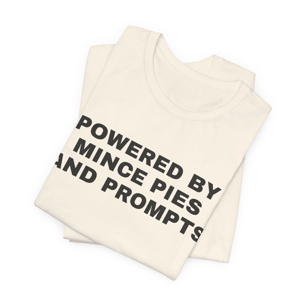 Natural t-shirt printed with 'Powered by Mince Pies and Prompts', folded