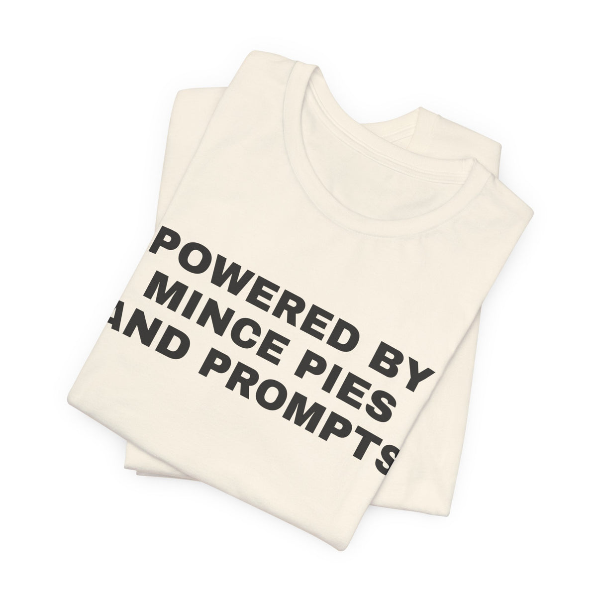 Natural t-shirt printed with 'Powered by Mince Pies and Prompts', folded