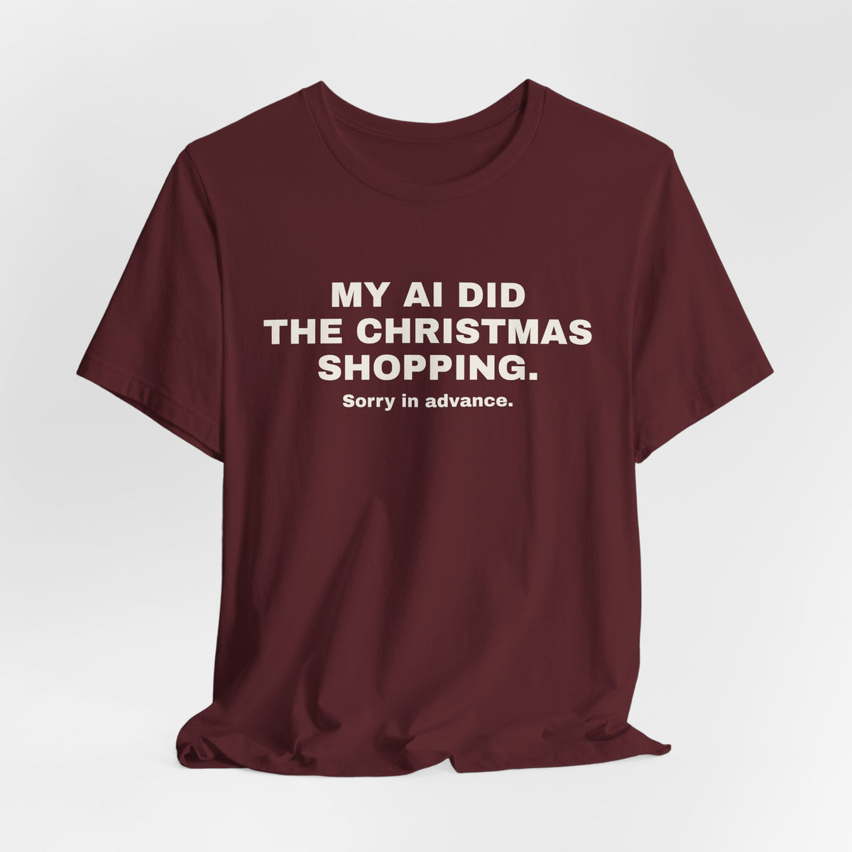 Maroon t-shirt printed with 'My AI Did the Christmas Shopping. Sorry in Advance.'