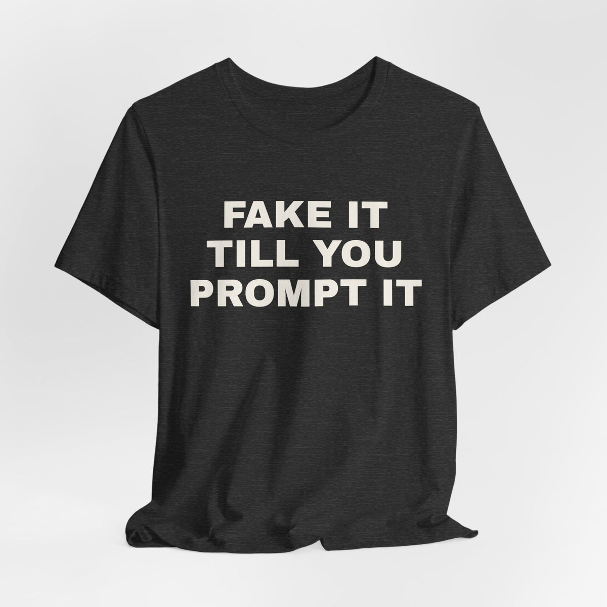 Dark grey heather t-shirt printed with 'Fake it till you prompt it'