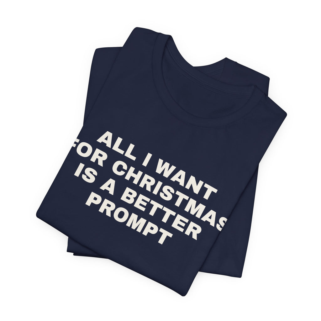 Navy t-shirt printed with 'All I want for Christmas is a better prompt', folded