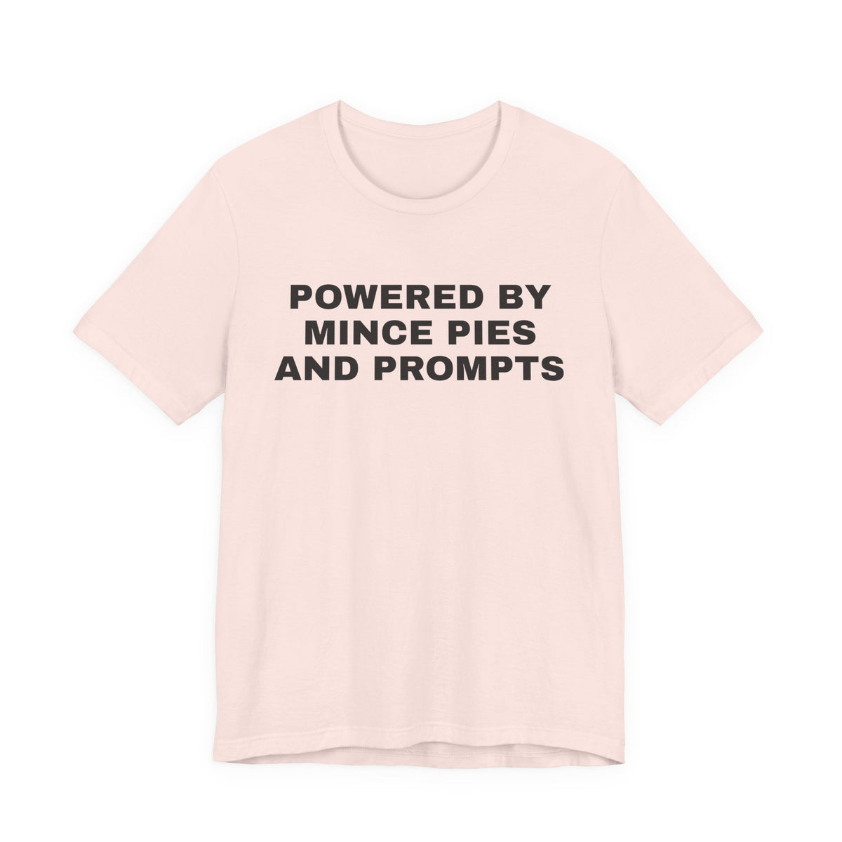 Soft pink t-shirt printed with 'Powered by Mince Pies and Prompts'