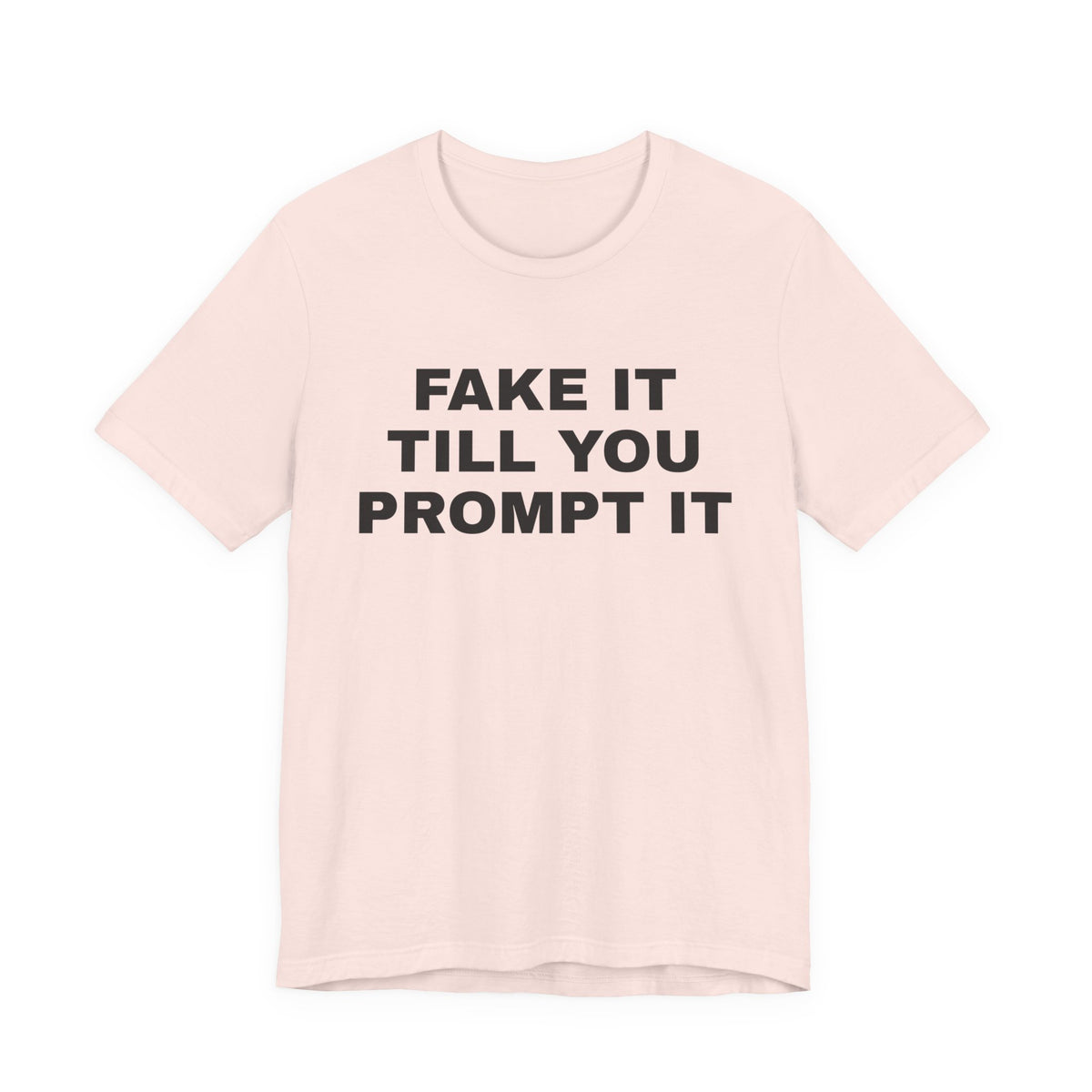Soft pink t-shirt printed with 'Fake it till you prompt it'