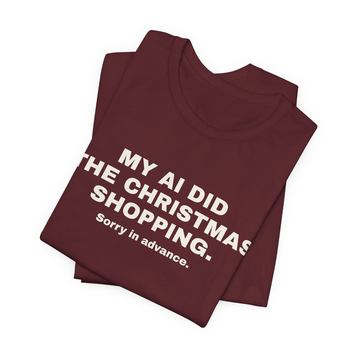 Maroon t-shirt printed with 'My AI Did the Christmas Shopping. Sorry in Advance.', folded