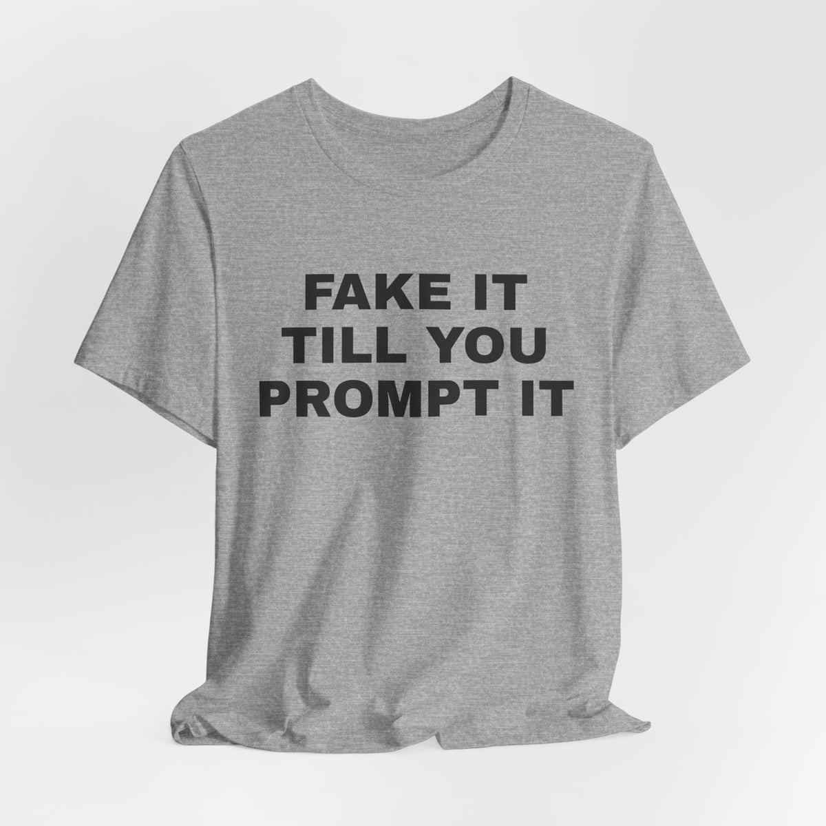 Athletic heather t-shirt printed with 'Fake it till you prompt it'