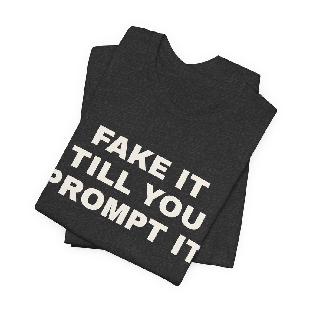 Dark grey heather t-shirt printed with 'Fake it till you prompt it', folded