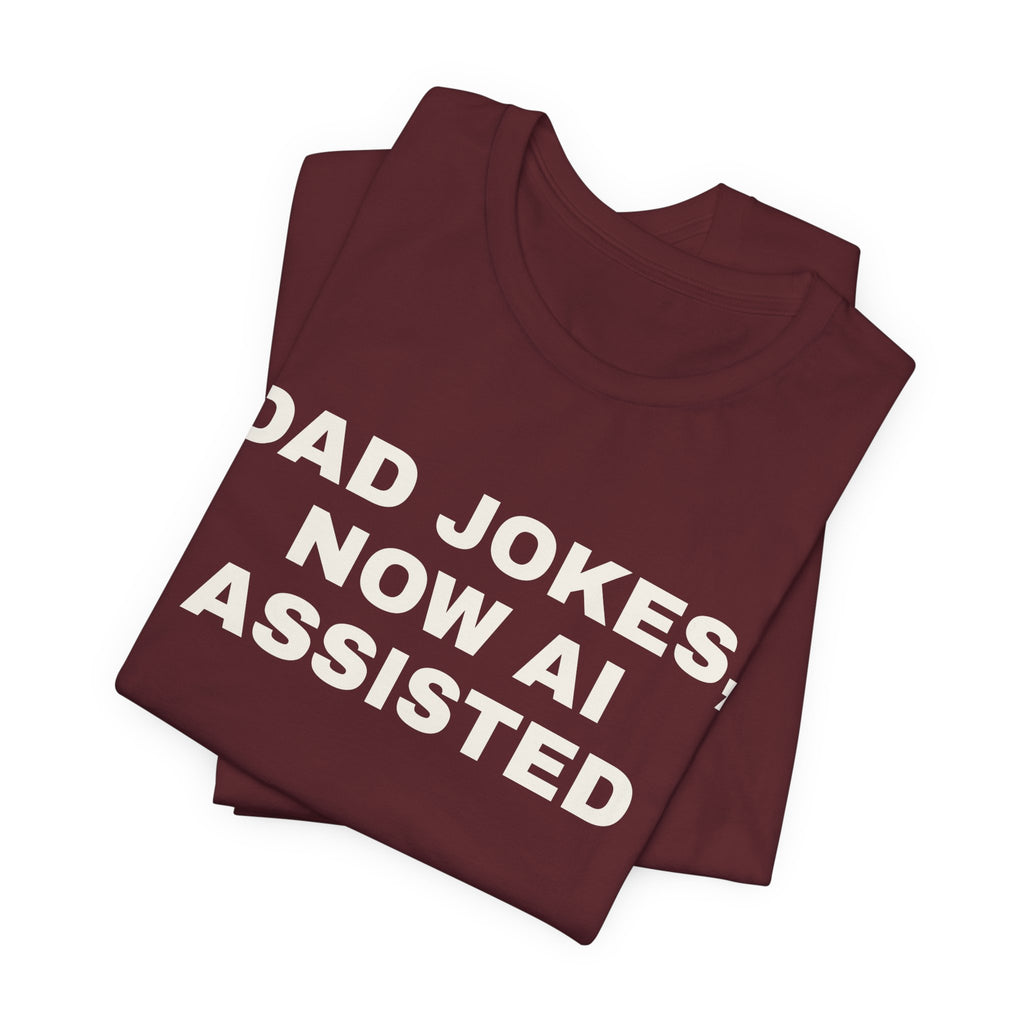 Maroon t-shirt printed with 'Dad jokes, now AI assisted', folded