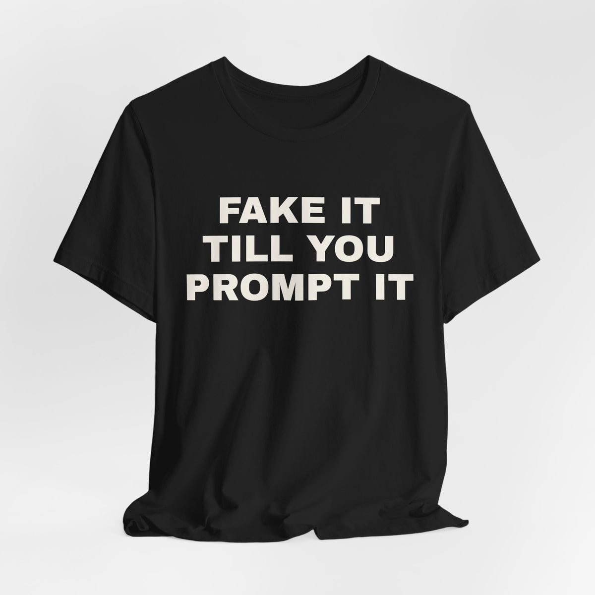 Black t-shirt printed with 'Fake it till you prompt it'