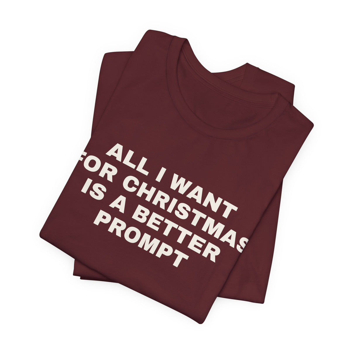 Maroon t-shirt printed with 'All I want for Christmas is a better prompt', folded