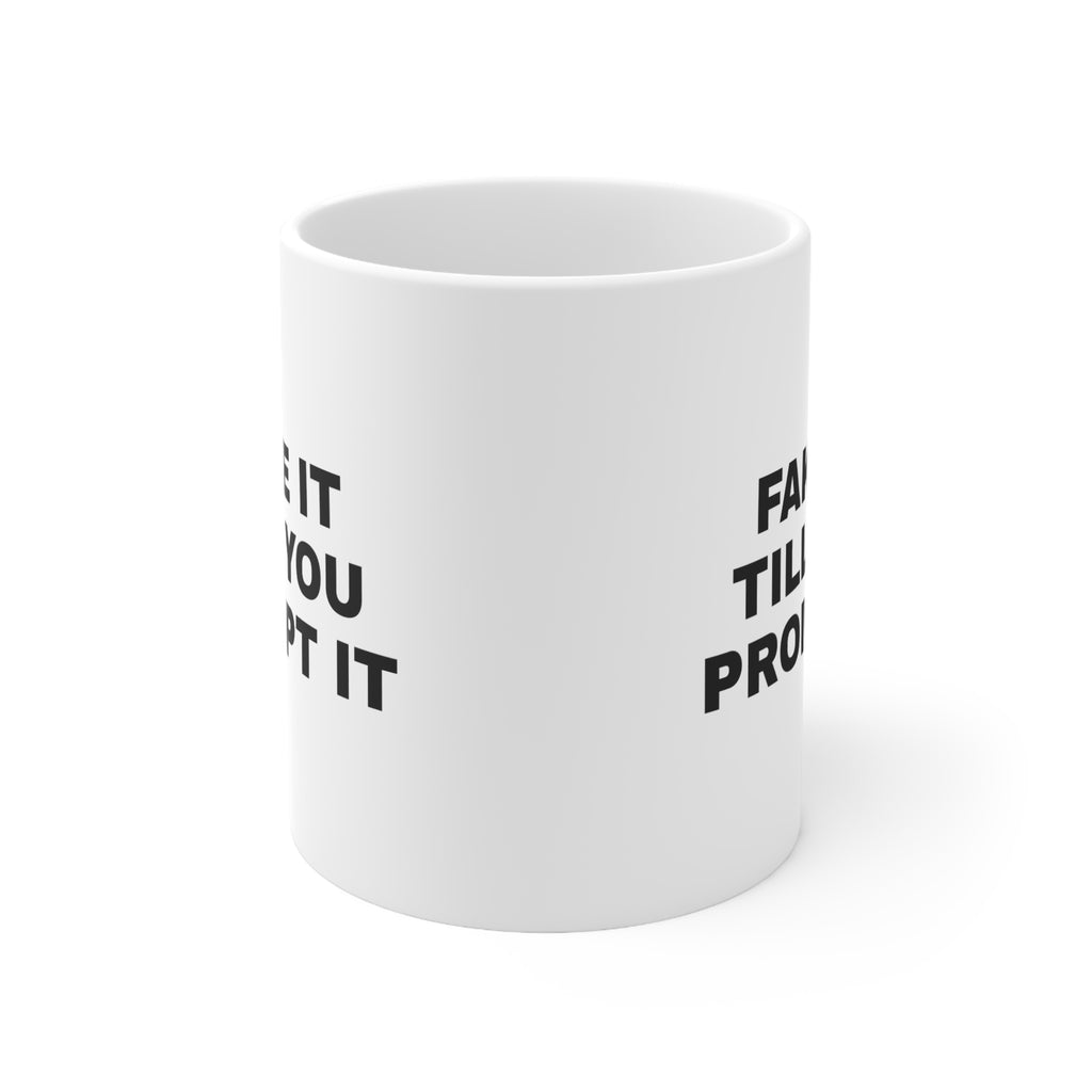 White mug printed with 'Fake it till you prompt it'