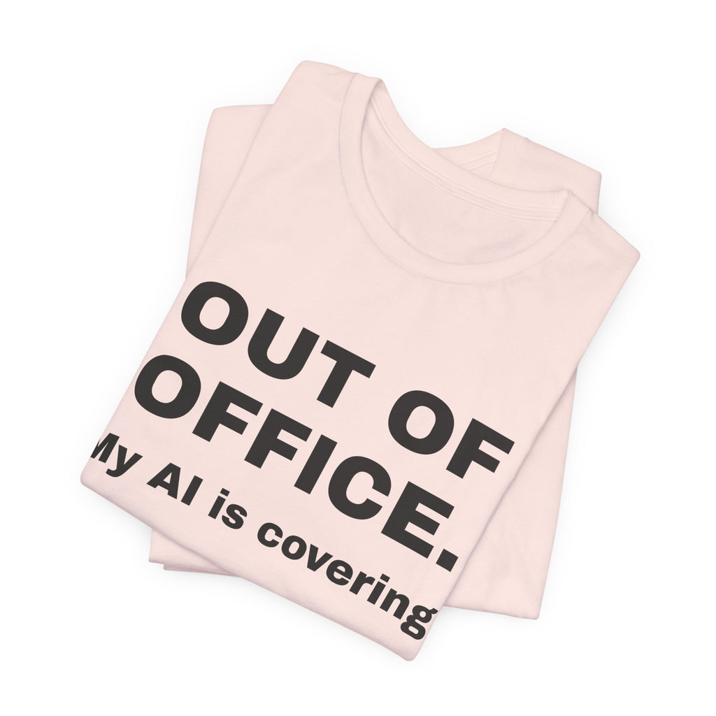 Soft pink t-shirt printed with 'Out of office. My AI is covering.', folded