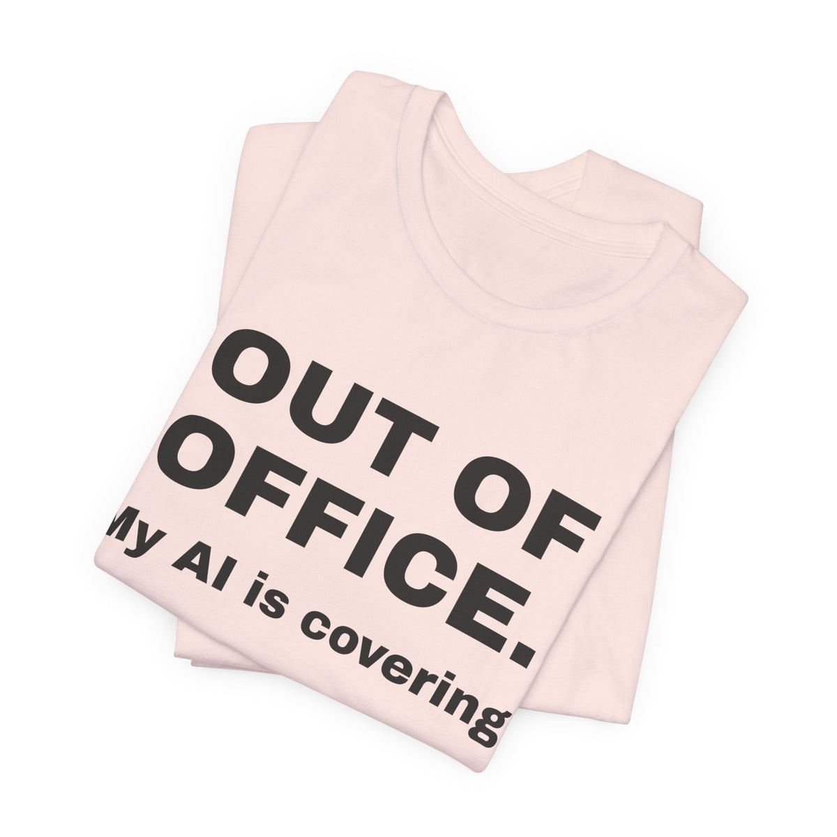 Soft pink t-shirt printed with 'Out of office. My AI is covering.', folded