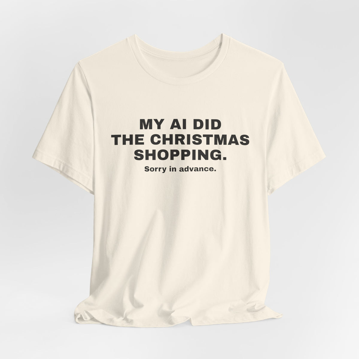 Natural t-shirt printed with 'My AI Did the Christmas Shopping. Sorry in Advance.'