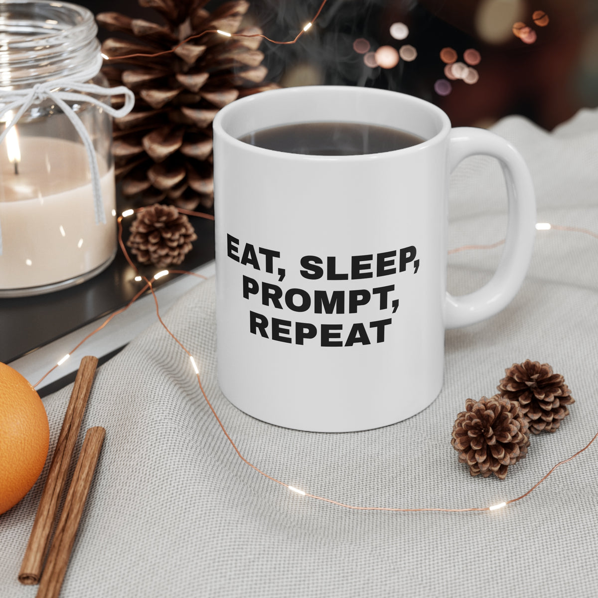 White mug printed with 'Eat, sleep, prompt, repeat', on a festive table